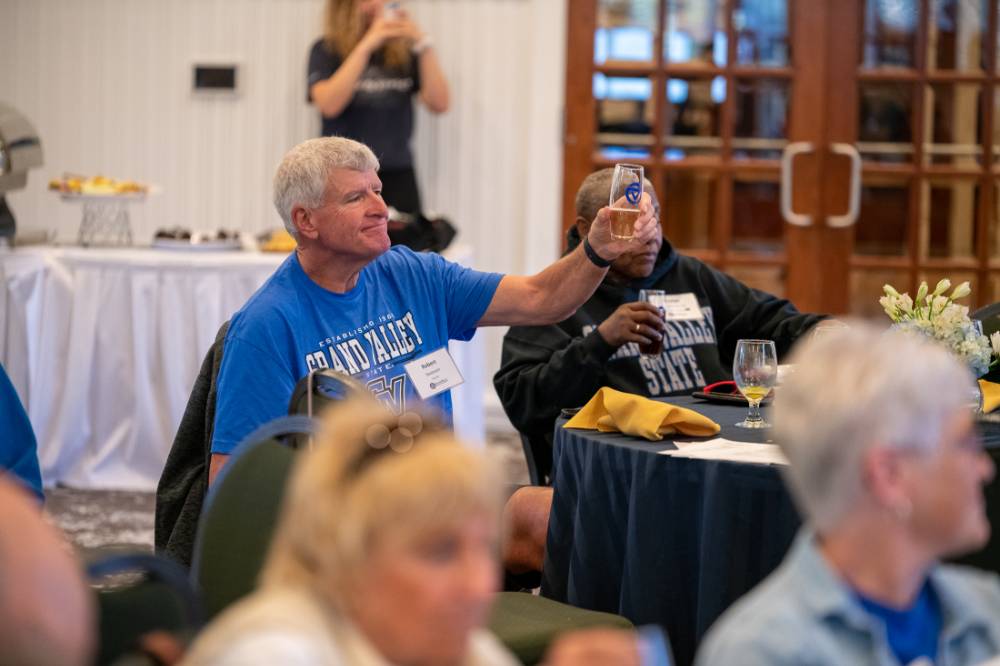 An alumni raising a toast.